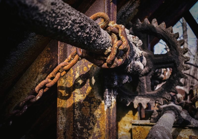 Rusted chain running over a toothed sprocket
