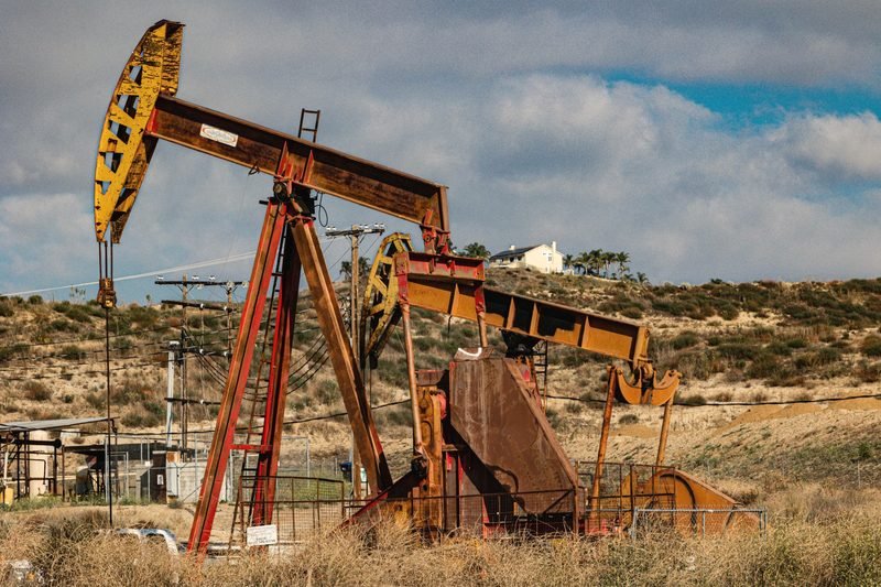 A weathered pumpjack in dry scrub